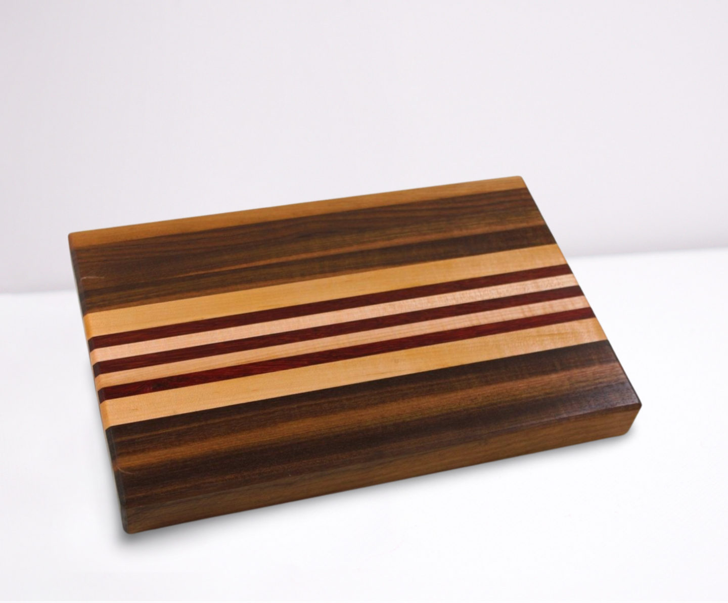 Wooden cutting board with striped pattern on a white background