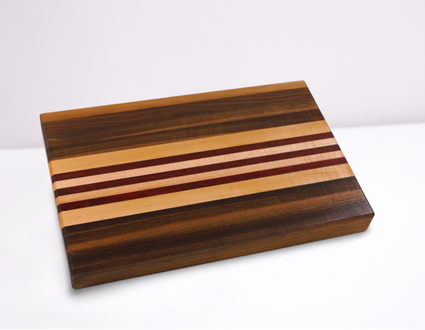 Wooden cutting board with striped pattern on a white background
