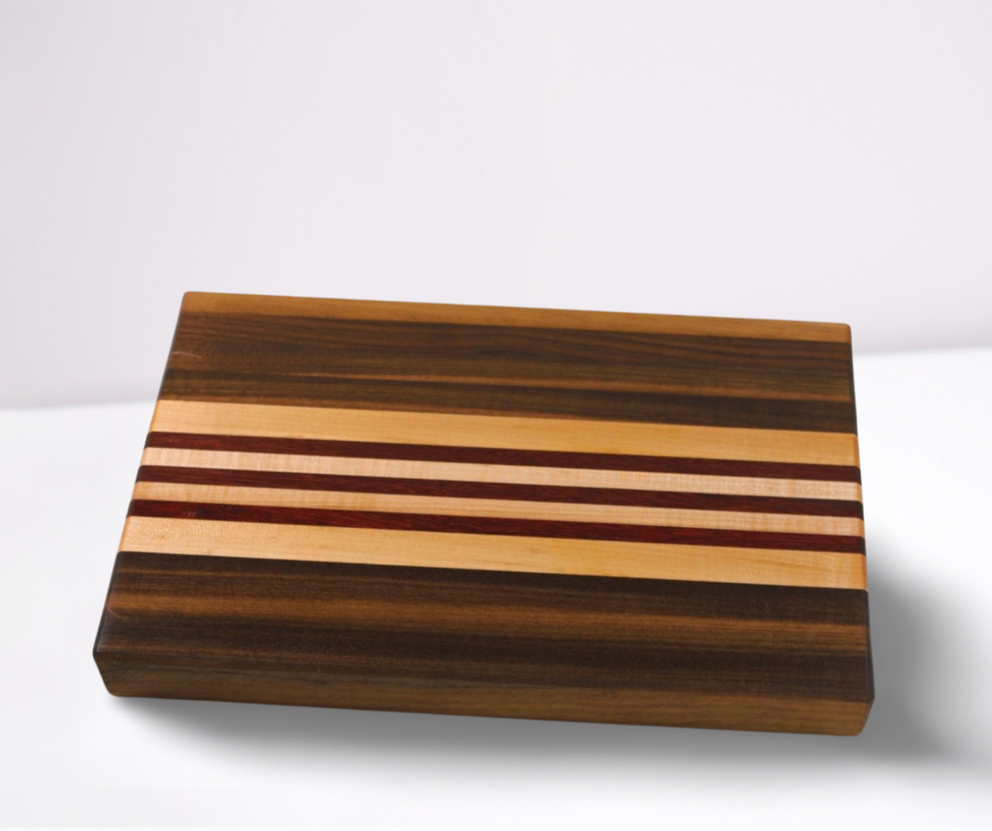 Wooden cutting board with striped pattern on a white background