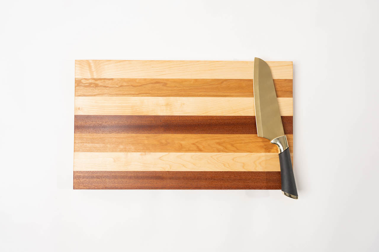 This handcrafted cutting board is made with a combination of luxurious African Mahogany, Maple, and Cherry wood.&nbsp;